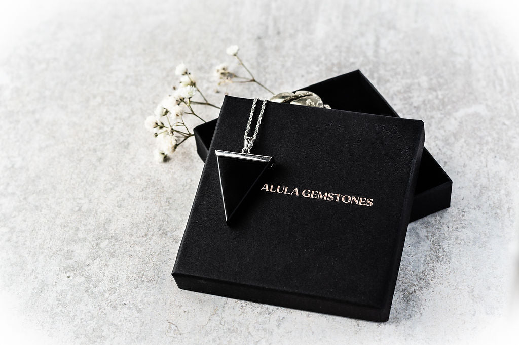 Black Oynx Necklace Pendant displayed on Alula Gemstones packaging